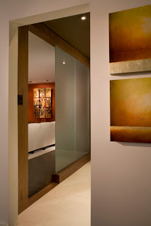 View of the design of the glass wall that allows light to filter to the bathroom 
