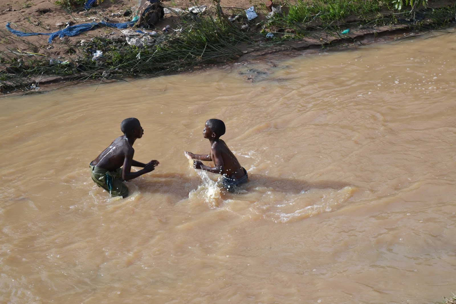 Health Matters Children Swimming in contaminated and dirty water in a