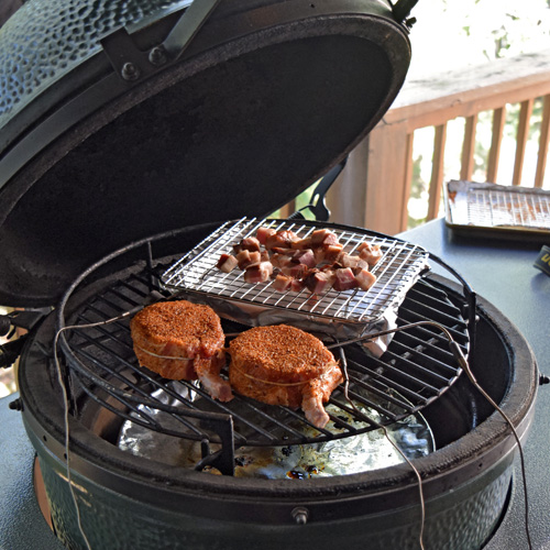 Smoking 2 bone in pork chops and some seasoning bacon on the Big Green Egg.