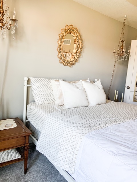 hanging chandelier next to bed