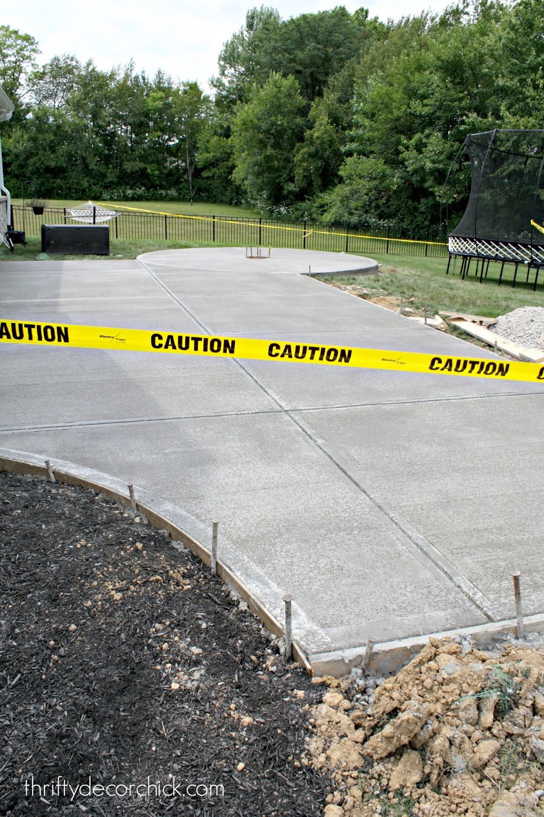 Large basic concrete patio with fire pit circle