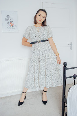 Girl wearing a white polka dot midi dress