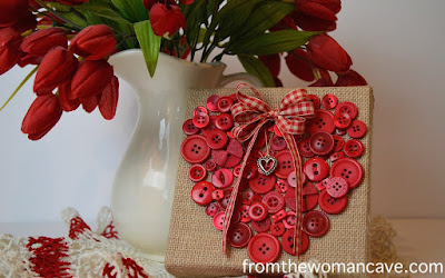 http://www.fromthewomancave.com/2015/01/14/a-pretty-little-button-heart-canvas/