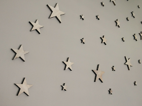 wooden stars on a grey wall