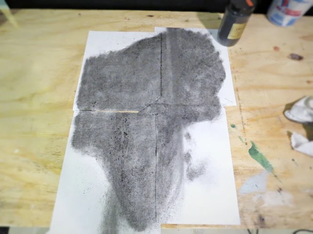 rubbing powdered charcoal on the back of the assembled photo