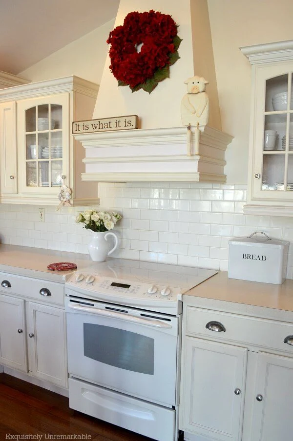 Red hydrangea wreath On cream colored Kitchen Hood