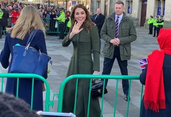 Kate Middleton wore a green Alexander McQueen coat, a print dress by Zara, Zeen ceramic earrings and Aspinal of London Mayfair bag