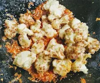 Tossing cauliflower florets for Gobi Manchurian recipe