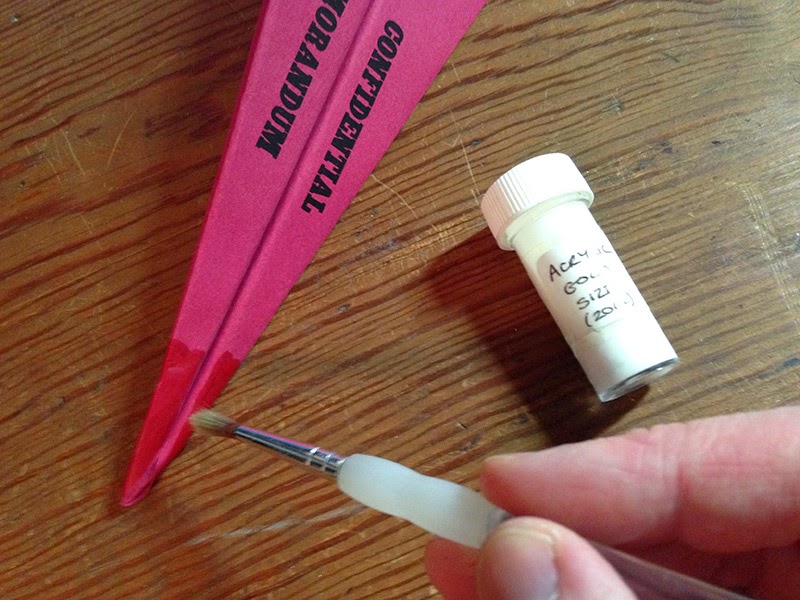 Painting Size on the nose of your memo How to paint the gold leaf glue over the dry red paint.