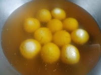 Orange rasgulla in orange color sugar syrup