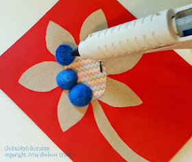 glue on felted wool balls to recycled flower cardboard wall art step 4
