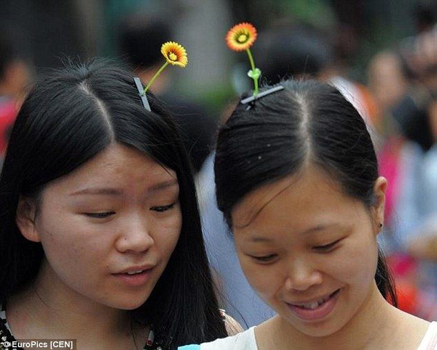 2 girls wearing flower hair pins