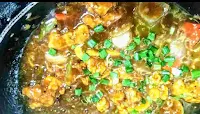 Chilli chicken gravy topped with spring onions