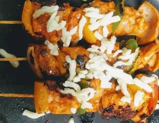 Chicken kebab topped with mozzarella cheese and cooking over tawa or pan for chicken kebab recipe without oven