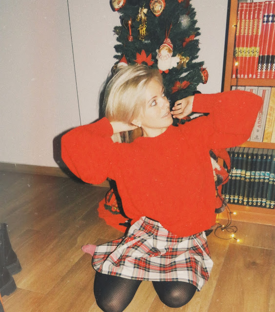 Alejandra Colomera con jersey rojo de manga abullonada, falda tartán blanco y medias negras