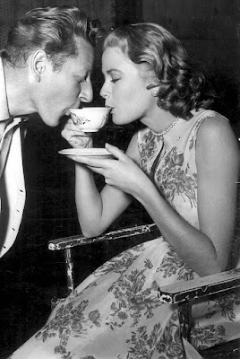 Danny Kaye and Grace Kelly drinking coffee.