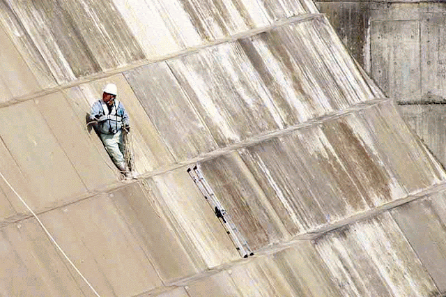 Dam worker, rope and ladder
