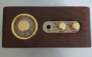 Top view of the speaker with radio, different modes, and volume control knobs