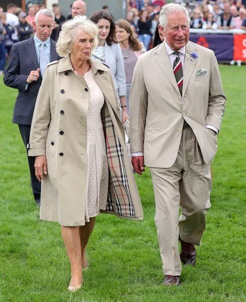 Prince Charles and Duchess of Cornwall met with King Goodwill and Queen Pumi of the Zulus. Burberry trench coat