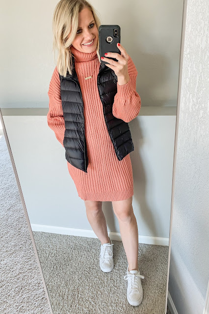 Orange sweater dress with a best and sneakers