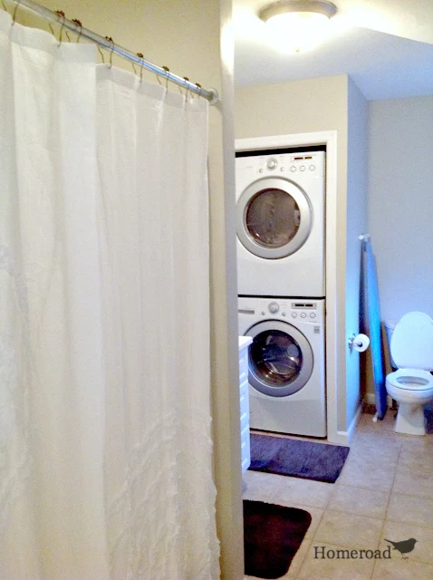 bathroom with stackable washer and dryer