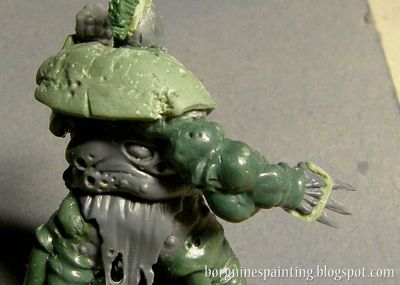 Another arm of the Putrid Blightking miniature is visible here, bloated and out-of-proportions, made out of many round blobs of greenstuff.