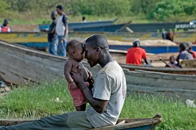 Daddy telling African folklore stories to his child in Ghana