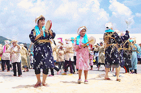 women and young girls dancing,chanting, sand, drums