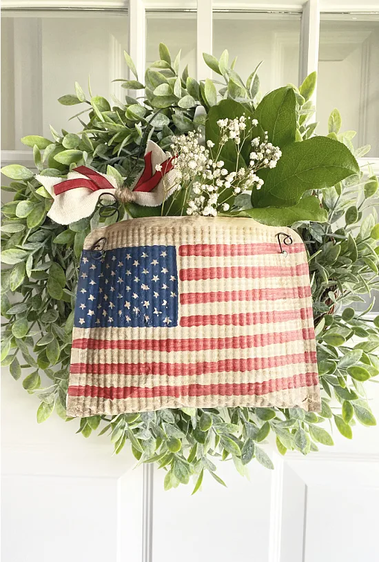 wreath with flag pouch on door