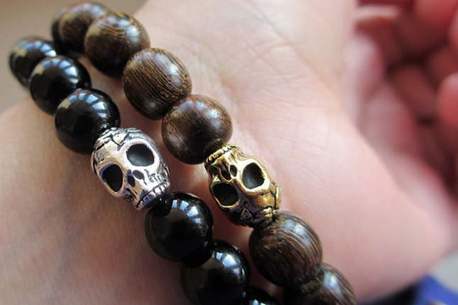 Binchohan Skull Wood Beaded Bracelets Two Binchohan Skull Beaded Bracelets on a wrist