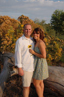 couple standing in front of a flowering tree