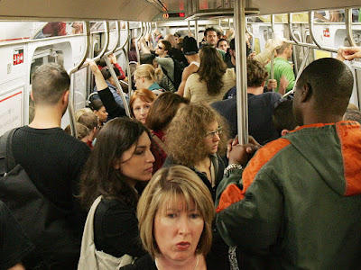 Image description: a crowded  pre-covid subway car