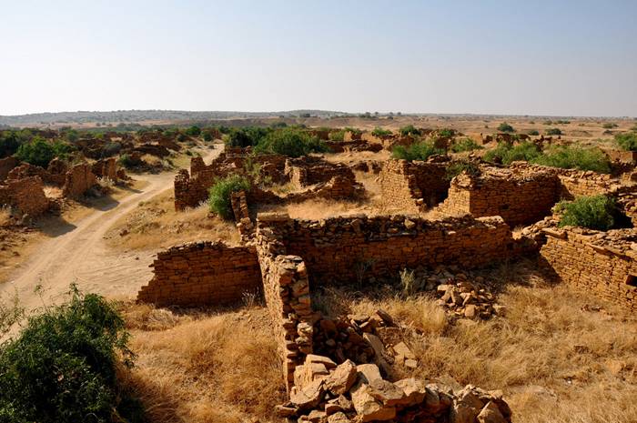Kuldhara village near Jaisalmer has a very unique history! It is said that the residents of 84 neighboring villages including Kuldhara vacated the villages overnight around 170 years back!! No one is sure where they have gone, but they are believed to have migrated to a place somewhere near Jodhpur. The residents were Paliwal Brahmans — said to be very intelligent, and residing there for about 500 years. So what made them do such an act? Stories say that the ruler of these villages pounded the Paliwals with heavy taxes and treated them very inhumanly; the ruler was unethical and forceful to them. They had no alternative, but to vacate all the 84 villages overnight and just disappear from the vision and reach of the ruler.  When the Paliwals left the villages, they left a curse that nobody can inhabit the villages ever. Residents of Jaisalmer say that there have been some attempts by some families to stay there, but they did not succeed.