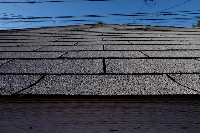 garage roof shingles against blue sky