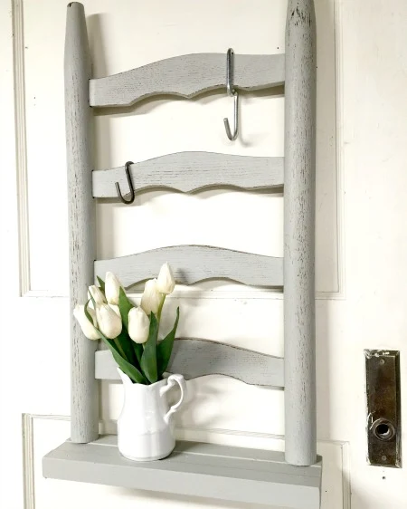 Grey ladder backed shelf with flowers