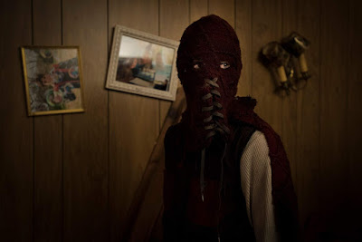Brightburn 2019 movie still where Jackson A. Dunn's character Brandon puts on his special red mask and cape to use his powers for evil purposes