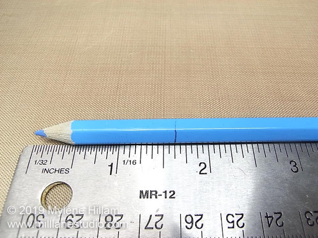 Placing a mark on the pencil for cutting.