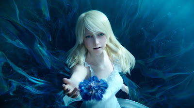 Screenshot of Lunafreya from Final Fantasy XV, appearing to sink into water