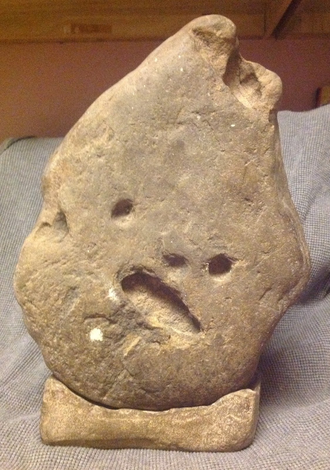 Archaeology of Portable Rock Art Face on possible oversized tool form
