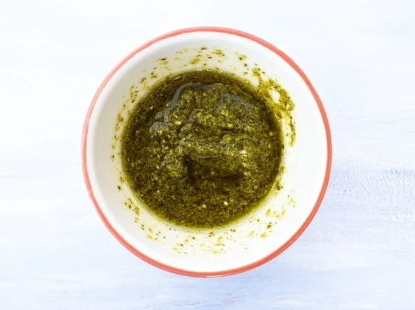 small white bowl half filled with pesto