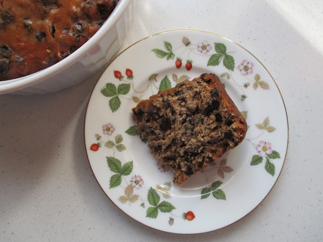 A slice of Irish barmbrack on a wild strawberry plate.