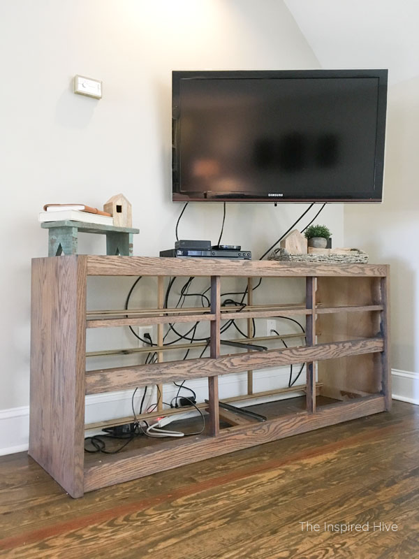 Dresser makeover. How I turned an old dresser into a modern farmhouse style entertainment center. This TV stand has weathered wood, black paint, and antique brass hardware.
