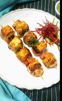 Paneer tikka in a garnished plate