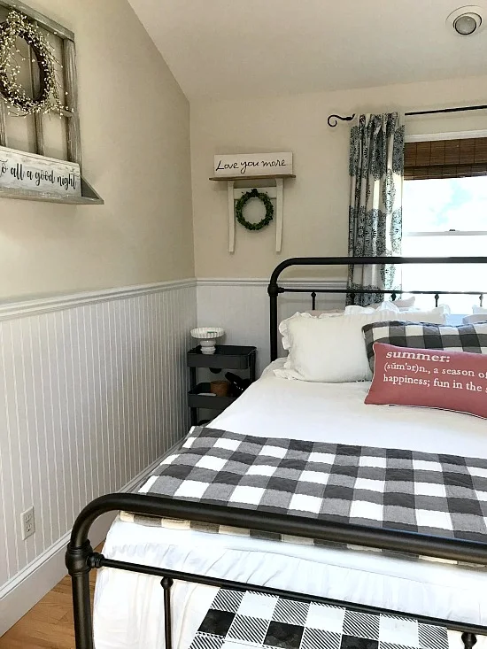 bedroom with iron bed and repurposed chair shelf