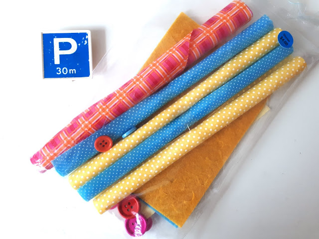 Package of rolled fabric pieces with coordinating felt pieces and buttons. On the pack is a price tag that says 'Vinnies $4'