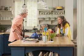 Grace and Frankie kitchen in beach house with blue cabinets