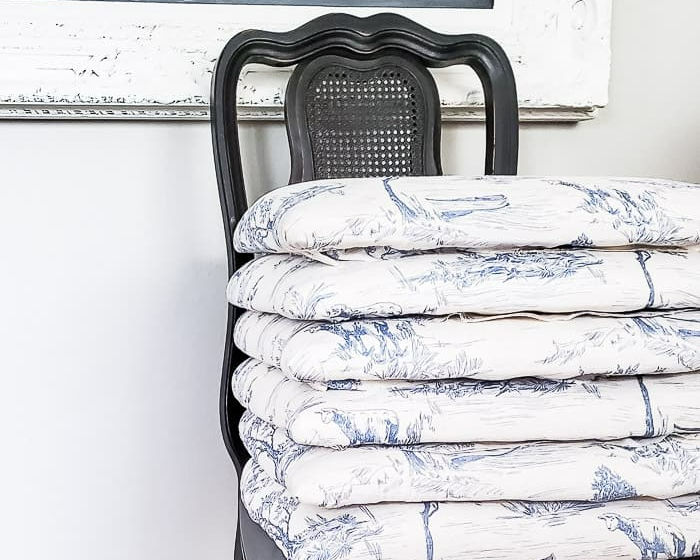 stack of blue toile recovered chair seat cushions