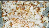 Frying onion slices for mutton masala