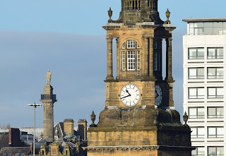 All Saints Church clock tower with The Earl Grey Monument visible behind