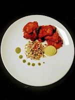 Serving fish Tikka with cilantro mint chutney, lemon wedges and sprouts salad for fish tikka recipe